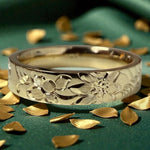 The Bloom Band delicate hand-engraved floral rings in daisy and rose motifs available in multiple metals and sizes
