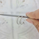 Round brilliant cut diamond hoop earrings in 18kt white gold with claw-set diamonds