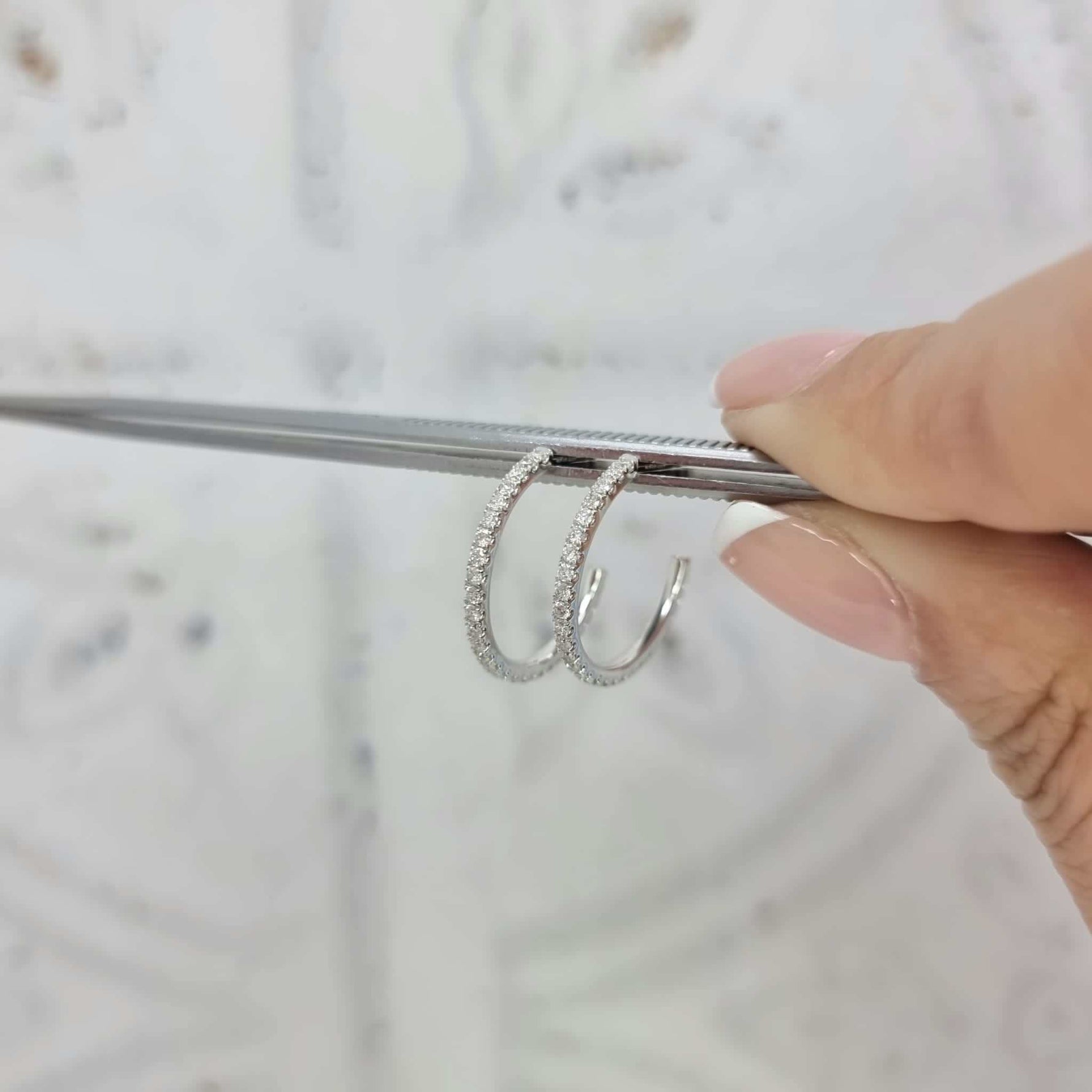 Round brilliant cut diamond hoop earrings in 18kt white gold with claw-set diamonds