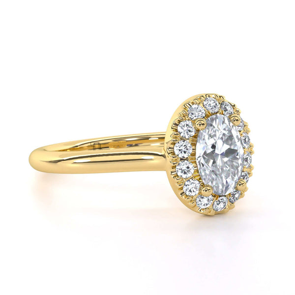 Jennifer Oval engagement ring with oval cut diamond center and halo diamonds in gold setting