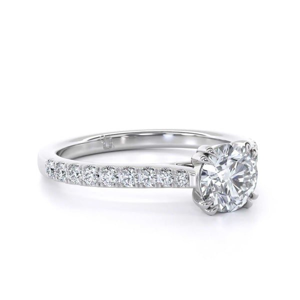 Dolly diamond ring with brilliant round cut and micro set diamond shoulders in double claw design