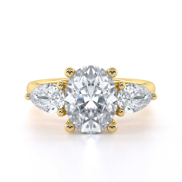 Oval and pear shape trilogy diamond engagement ring