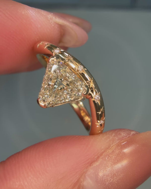 Trillion cut diamond curved engagement ring with elegant modern design