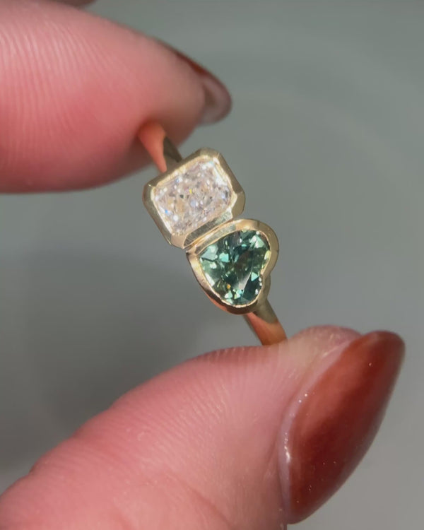 Radiant cut diamond and teal sapphire toi et moi ring